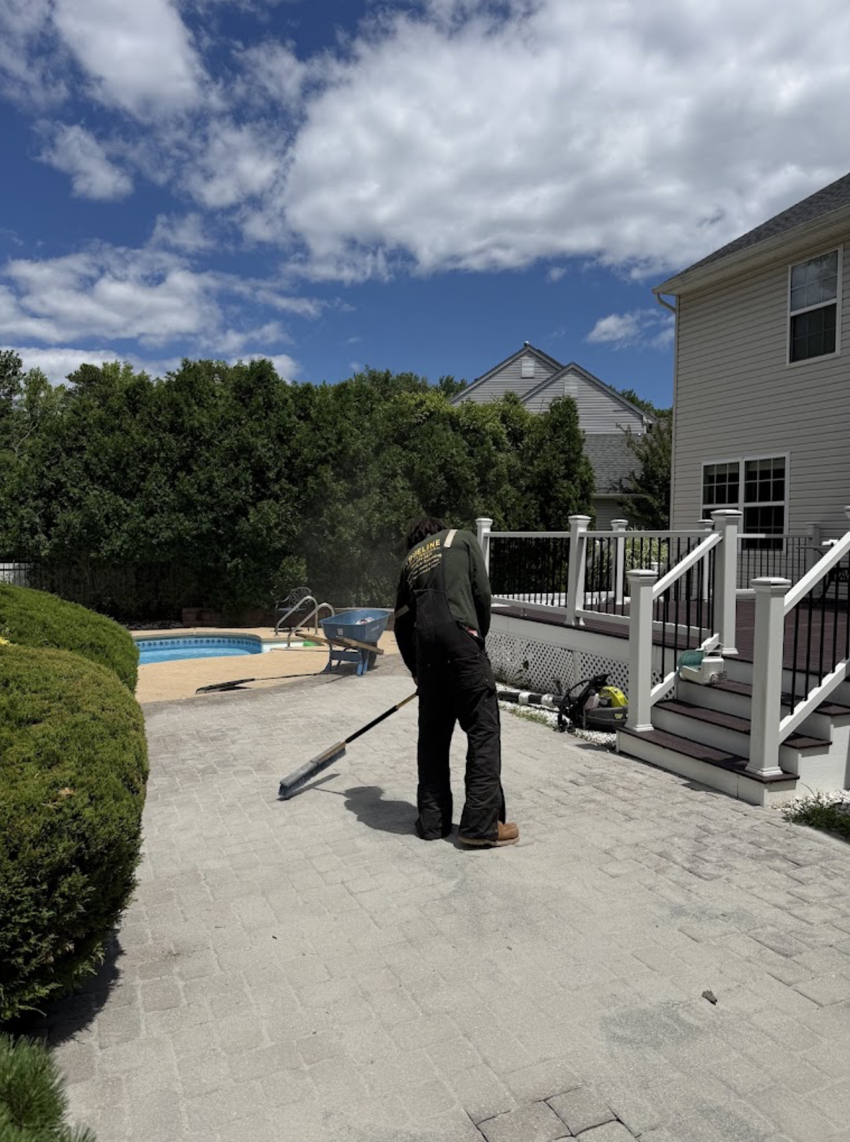 TrueLine worker preparing a paver patio near a residential pool